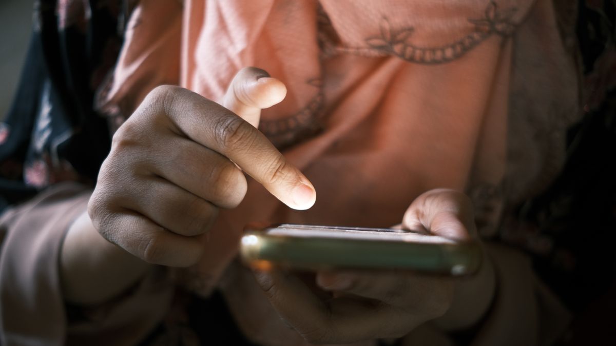 Person scrolling a social media feed on a phone