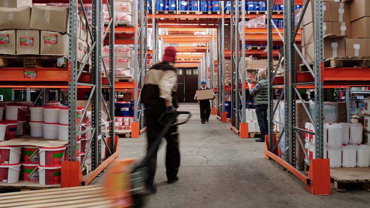 Warehouse worker between shelves